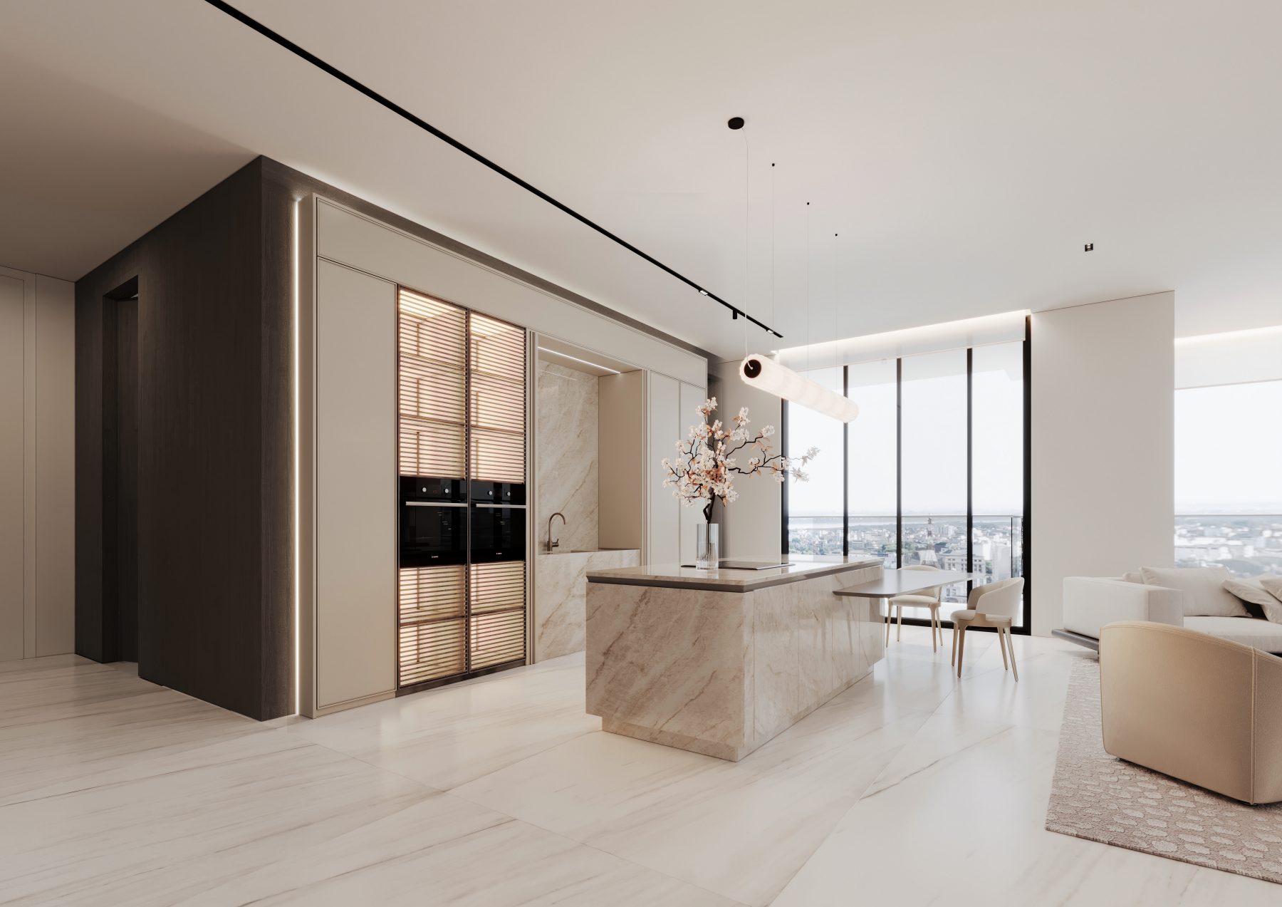 Pale stone kitchen island beside floor-to-ceiling windows.