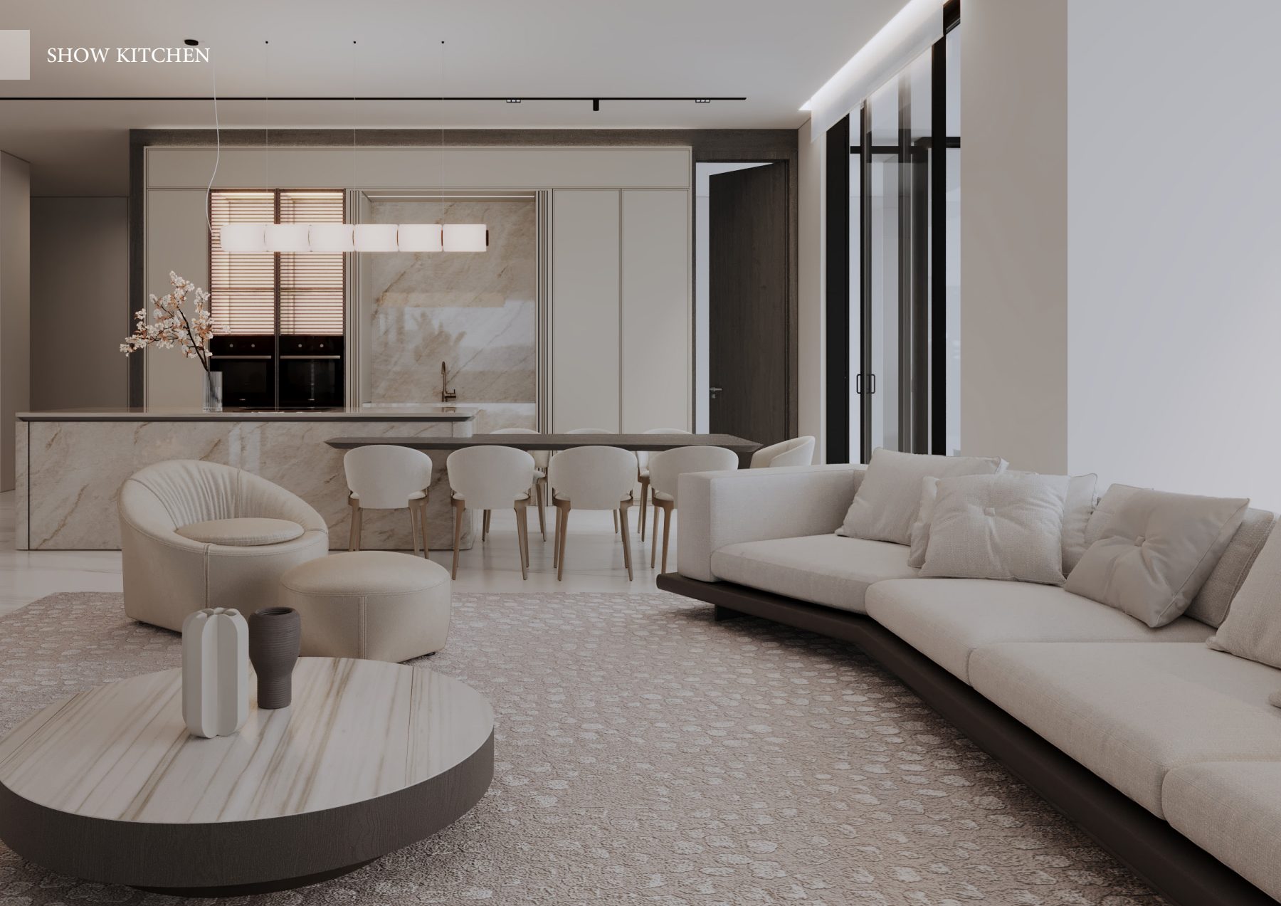 Curved cream sofa facing a stone kitchen island in an open-plan living room.