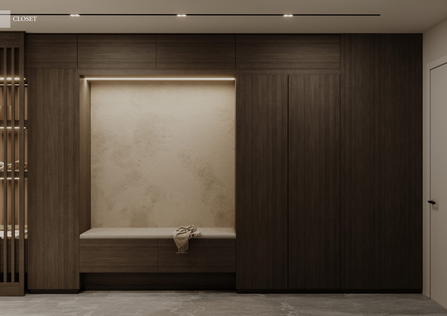 Recessed dressing bench within dark timber wardrobes.